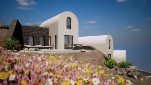a rendering of a church with flowers in the foreground at Bay View Residences Santorini in Akrotiri