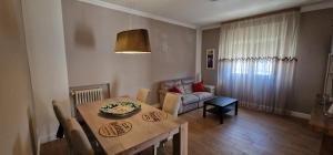 a dining room with a table and a couch at Casa GIOIA Luxury in Taranto