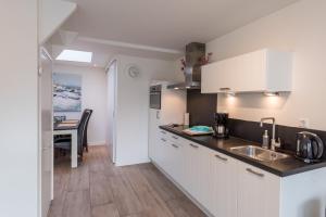 a kitchen with a sink and a counter top at SummerTime Bergen aan Zee in Bergen aan Zee