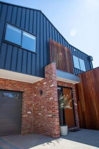 a brick house with a garage and a building at The McKinlay Station View in Echuca