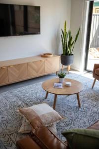 a living room with a couch and a coffee table at The McKinlay Station View in Echuca