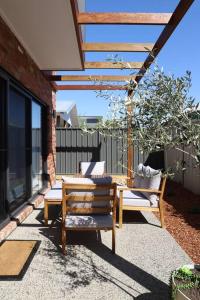 a patio with two chairs and a table at The McKinlay Station View in Echuca