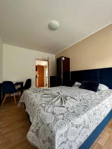 a bedroom with a large bed and a table at Ośrodek Wczasowy Camping Morski in Ustka