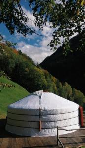 a mattress sitting on a table in a field at Panorama Jurte über dem Uri-See B in Sisikon