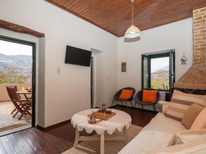 a living room with a couch and a table at Ornus Traditional House in Orné +14 photos
