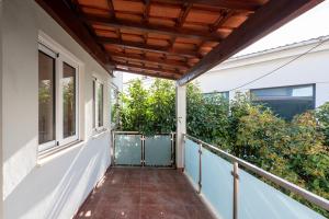 uma varanda com toldo e plantas numa casa em ALTIDO Warm and Inviting flat with balcony no Porto