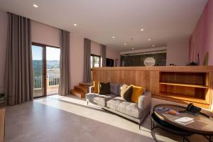 a living room with a couch and a table at Viewpoint Boutique Living in Xlendi