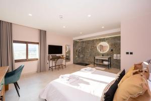 a hotel room with a bed and a fireplace at Viewpoint Boutique Living in Xlendi