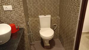 a bathroom with a toilet and a sink at Coconhuts Beach Resort in Neil Island +36 photos