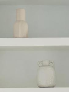 a white vase sitting on top of a shelf at Liverpool Peach House - 4 bedrooms in Liverpool