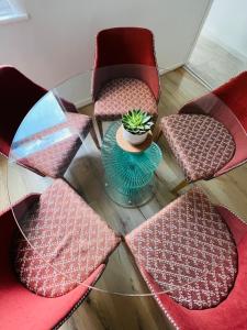 a glass table with chairs and a potted plant on it at Liverpool Peach House - 4 bedrooms in Liverpool