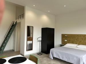 a bedroom with a bed and a staircase in it at Casa MaLa’ in Ceprano