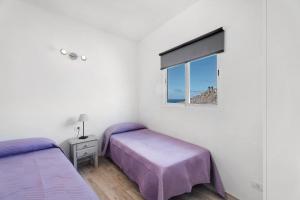 - une chambre avec 2 lits et une fenêtre dans l'établissement Vivienda vacacional La Era ll, à Vallehermoso