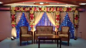 a room with a stage with chairs and a table at Castle Bay Touch Cox's Bazar in Cox's Bazar