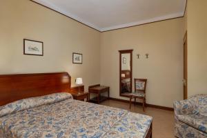 A bed or beds in a room at Albergo Reggio