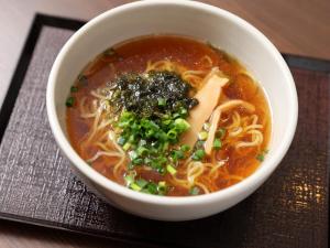 a bowl of soup sitting on a table at Dormy Inn Tokyo Hatchobori - Natural Hot Spring in Tokyo