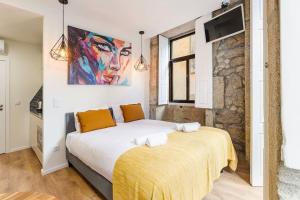 - une chambre avec un lit et une peinture murale dans l'établissement GuestReady - Estadia agradável perto dos Clérigos, à Porto