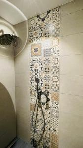 a bathroom with a camera on a tile wall at Kleine Burg Ovelgönne in Ovelgönne
