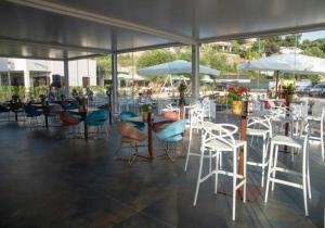 a restaurant with chairs and tables and umbrellas at Resort Petrasia in Villammare