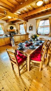 a wooden table in a kitchen with a dining room at Drevenička Anička - Liptovská Mara in Liptovský Trnovec