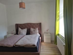 a bedroom with a bed with two pillows and a window at Ferienwohnung am Nationalpark Hunsrück Hochwald in Brücken