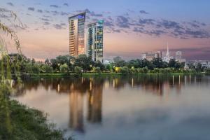 ein hohes Gebäude neben einem Wasserkörper in der Unterkunft Hilton Batumi in Batumi