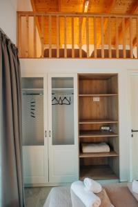 a room with a bunk bed and some glass doors at Villa di Vino in Lefkada Town