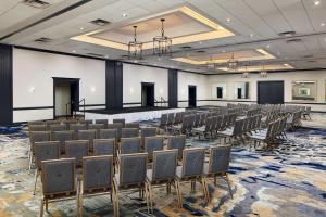 a large room with rows of chairs and a stage at Embassy Suites by Hilton West Palm Beach Central in West Palm Beach