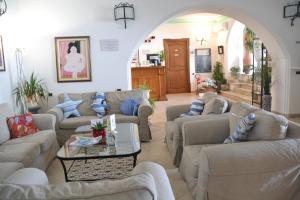 a living room with couches and a table at Hotel Ossidiana Stromboli Center in Stromboli