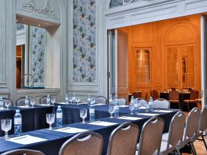 a meeting room with long tables and chairs at Palladio Hotel Buenos Aires - MGallery in Buenos Aires