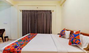 a bedroom with a large white bed with a window at Via Kings Suites in Bengaluru