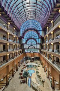 a large building with a pool and a glass ceiling at Anadolu Hotels Esenboga Thermal in Esenboga