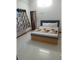 a bedroom with a bed in a room at Excel Hotel, Somnath in Somnath