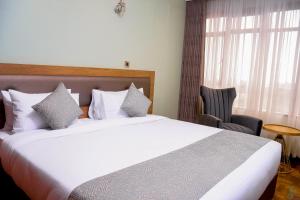 TJ's Boutique Hotel客房内的一张或多张床位