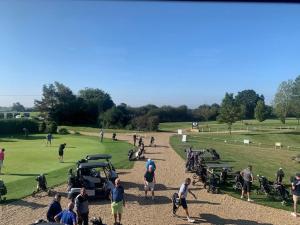 a group of people standing around a golf course at Silverstone Golf Club And Hotel in Silverstone