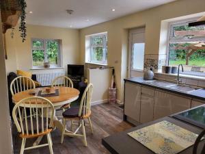 a kitchen with a table and chairs in a kitchen at Little Apples in Ringwood