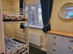 a bedroom with a bunk bed and a mirror at Little Apples in Ringwood