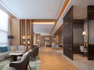 una hall di un hotel con divano e sedie di Novotel Yancheng Exhibition Center a Yancheng