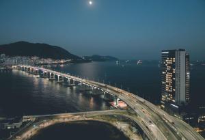 a large bridge over the water with traffic on it at Wyndham Grand Busan in Busan