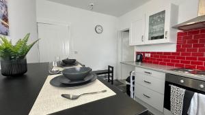 a kitchen with a table with a bowl and spoon on it at Snug apartment in the heart of Castleford in Castleford