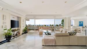 a living room with a couch and a table at Sky Villa in Marbella