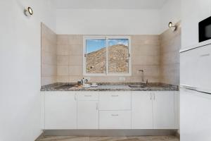a kitchen with a sink and a window at Vivienda vacacional La Era Il in Vallehermoso +21 photos