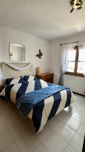 una camera da letto con un letto con un piumone blu e bianco di Casa Tranquila a Playa Honda
