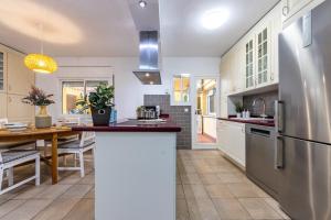 a kitchen with a stainless steel refrigerator and a table at Pepe’s Apartment Salou in Salou