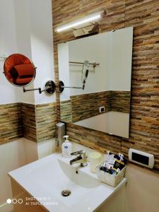a bathroom with a sink and a mirror at tulipano rosso in Bari +19 photos