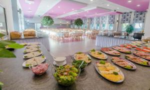 a buffet with many plates of food on a table at Ośrodek Wypoczynkowo-Leczniczy OPOLE w Dźwirzynie in Dźwirzyno