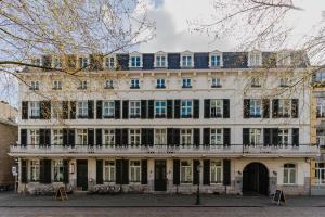 a large white building with a lot of windows at Hotel Monastère Maastricht in Maastricht