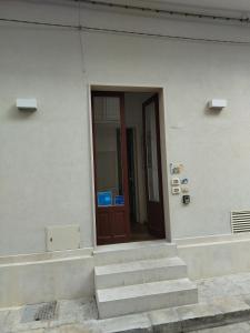 a door of a building with stairs in front at Le Logge in Scicli