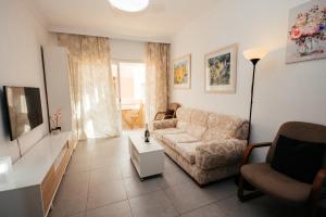 a living room with a couch and a table at La puntilla de las canteras in Las Palmas de Gran Canaria