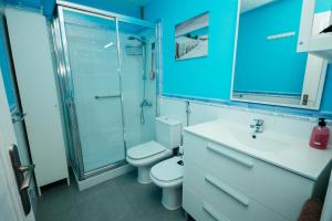 a bathroom with a toilet and a shower and a sink at La puntilla de las canteras in Las Palmas de Gran Canaria +36 photos